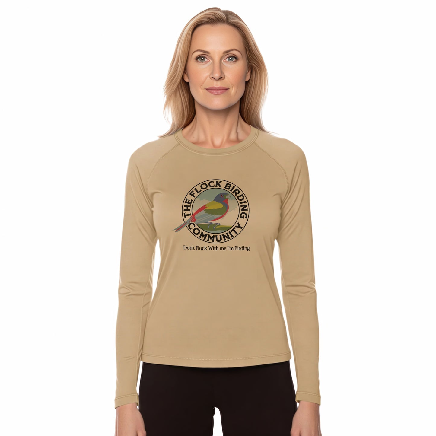 Woman wearing a beige long-sleeve shirt with a birding community logo on a white background