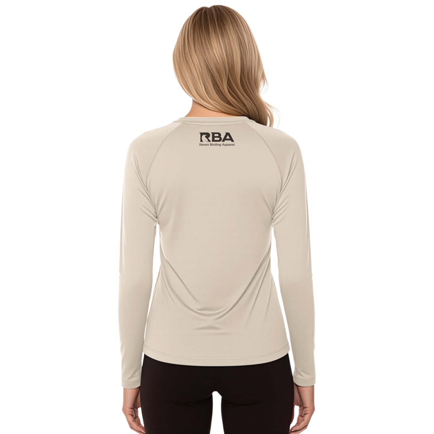 Beige long-sleeve shirt with 'RBA' logo on the back, worn by a person.