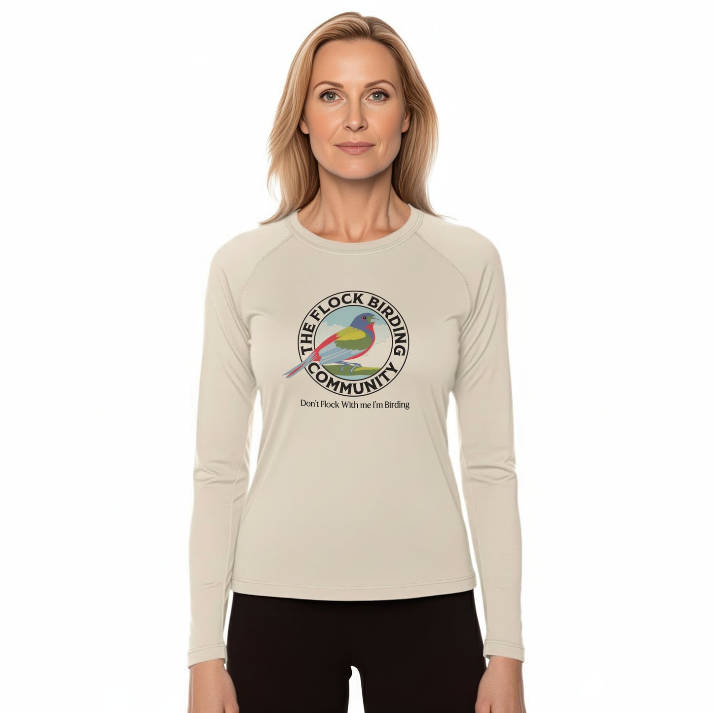 Woman wearing a beige long-sleeve shirt with a colorful birding community logo on a white background