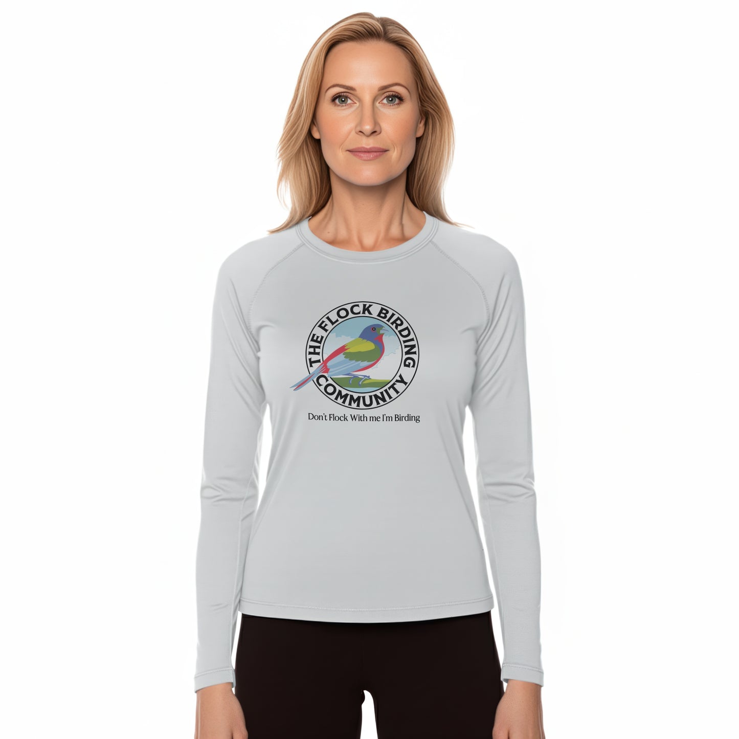 Woman wearing a gray long-sleeve shirt with a birding community logo on a white background