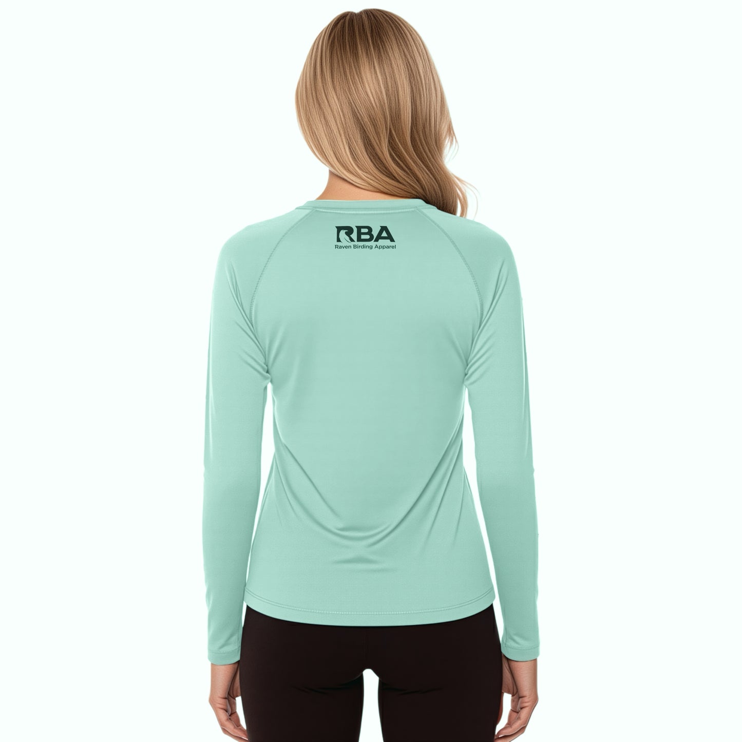 Person wearing a light blue long-sleeve shirt with 'RBA' logo on the back, on a white background