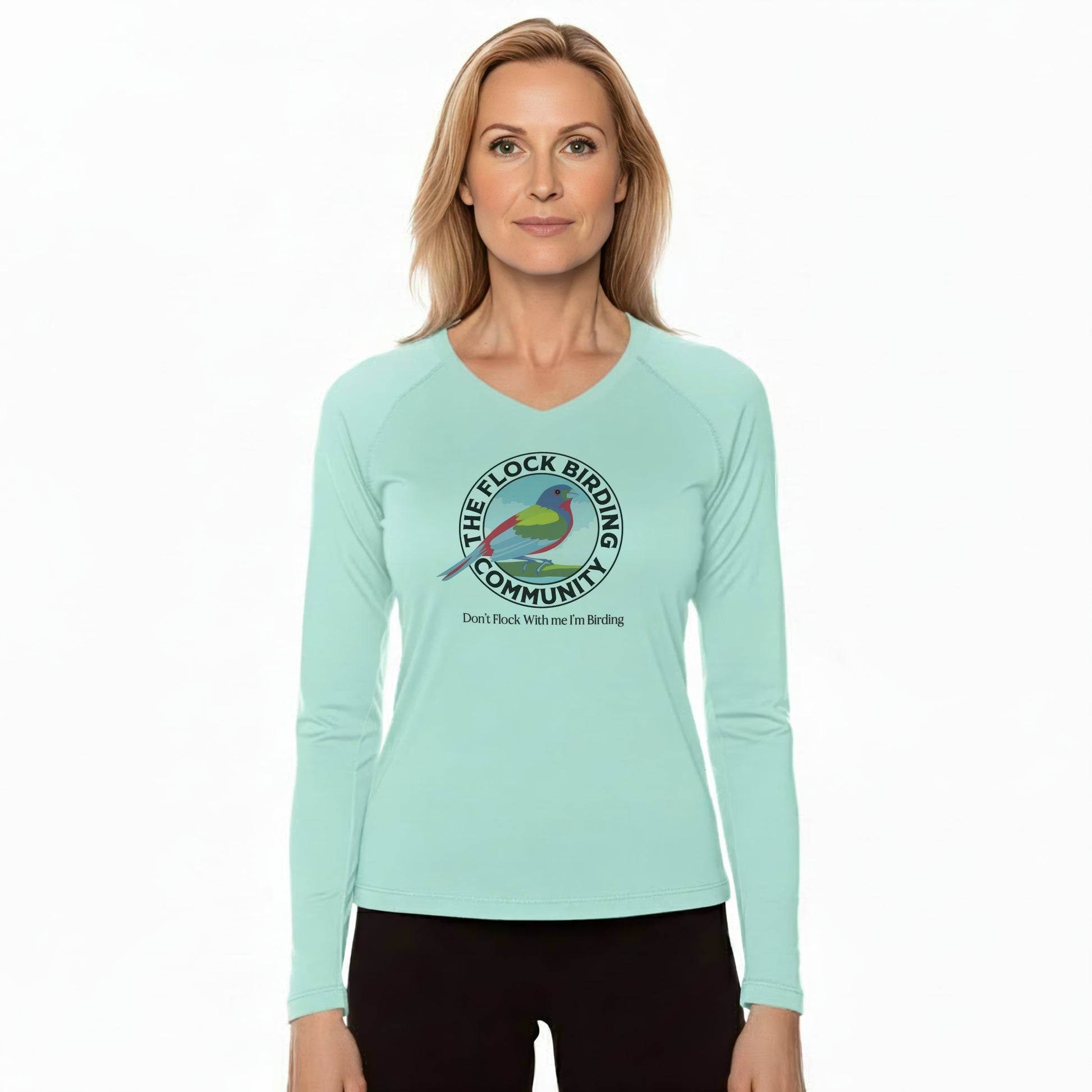 Woman wearing a light blue long-sleeve shirt with a bird-themed logo on a white background