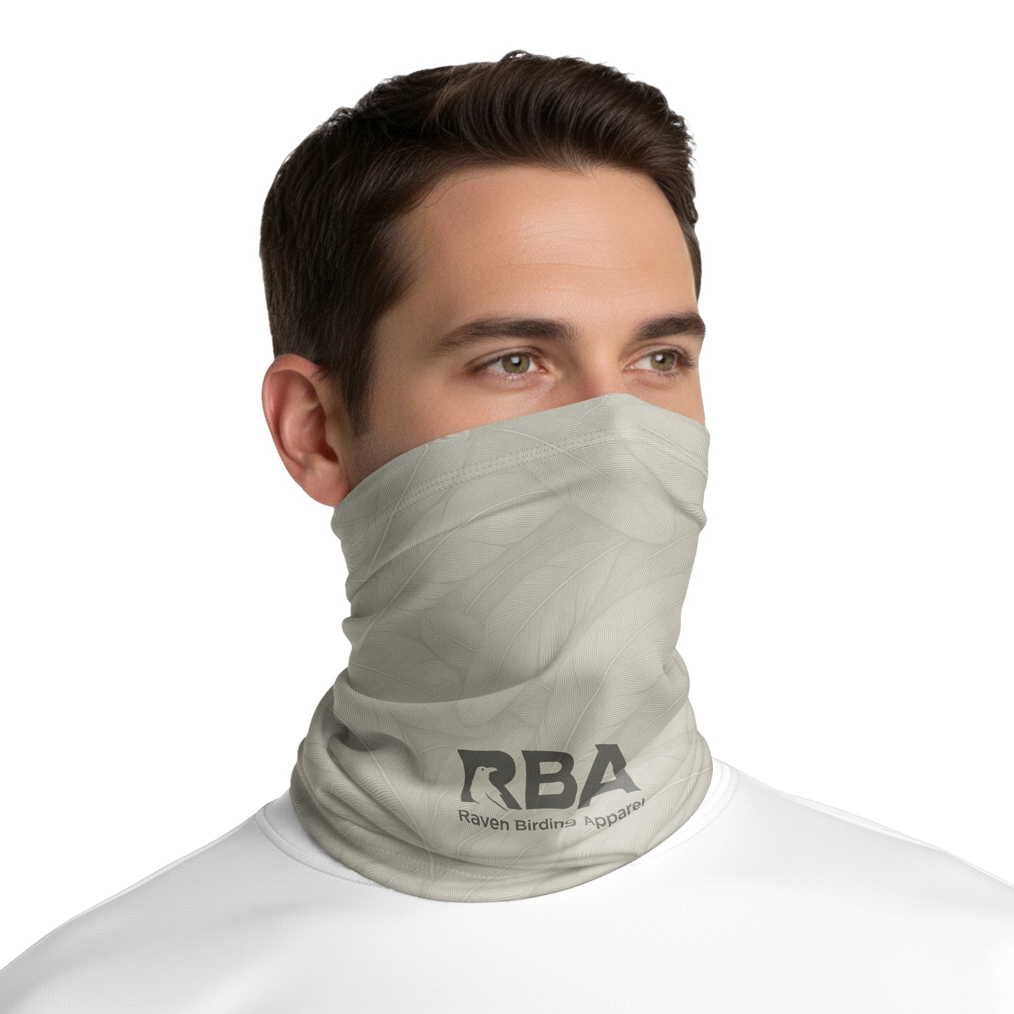 Man wearing a Desert Sand neck gaiter with a Raven Birding Apparel logo.