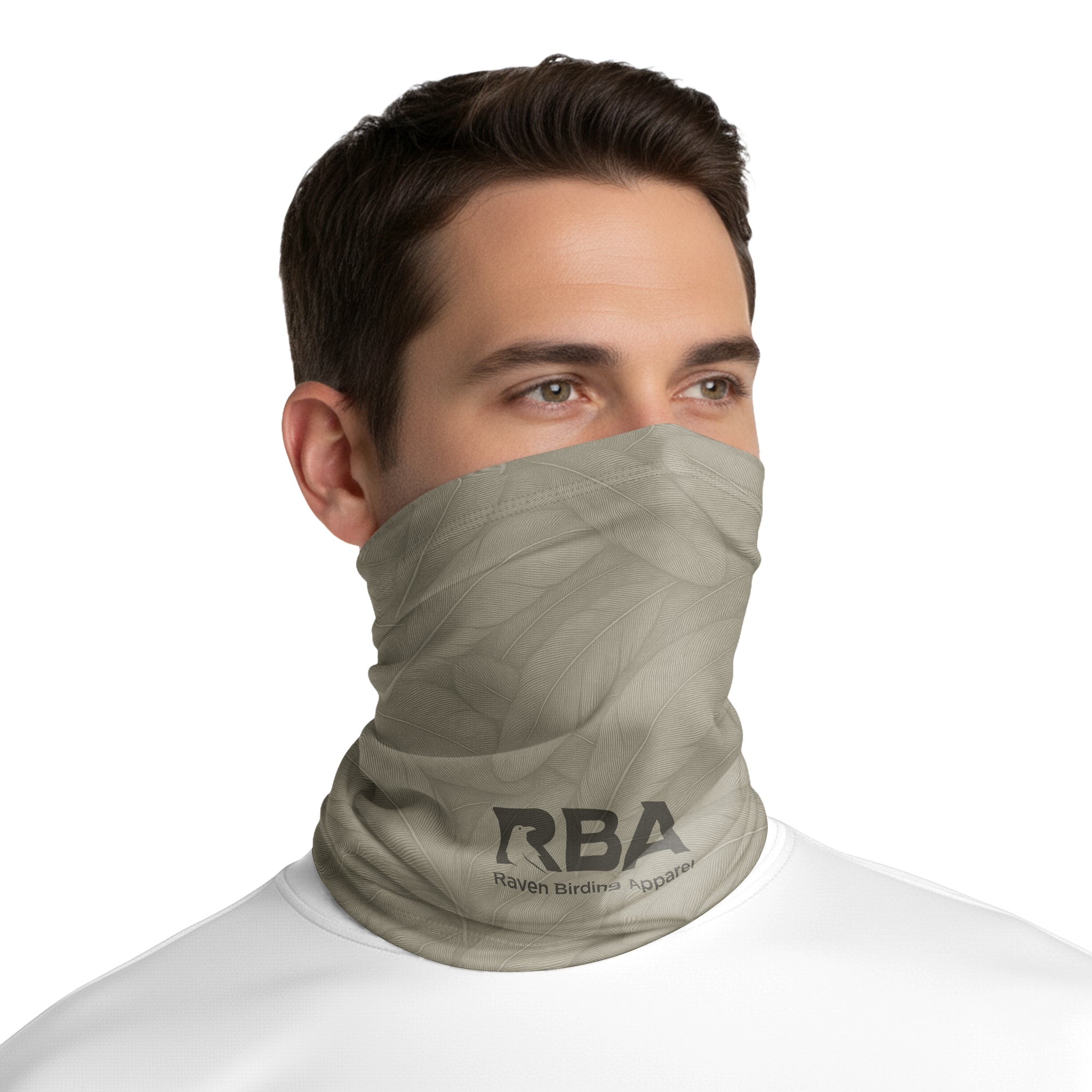 Man wearing a Fossil Stone neck gaiter with a Raven Birding Apparel logo.