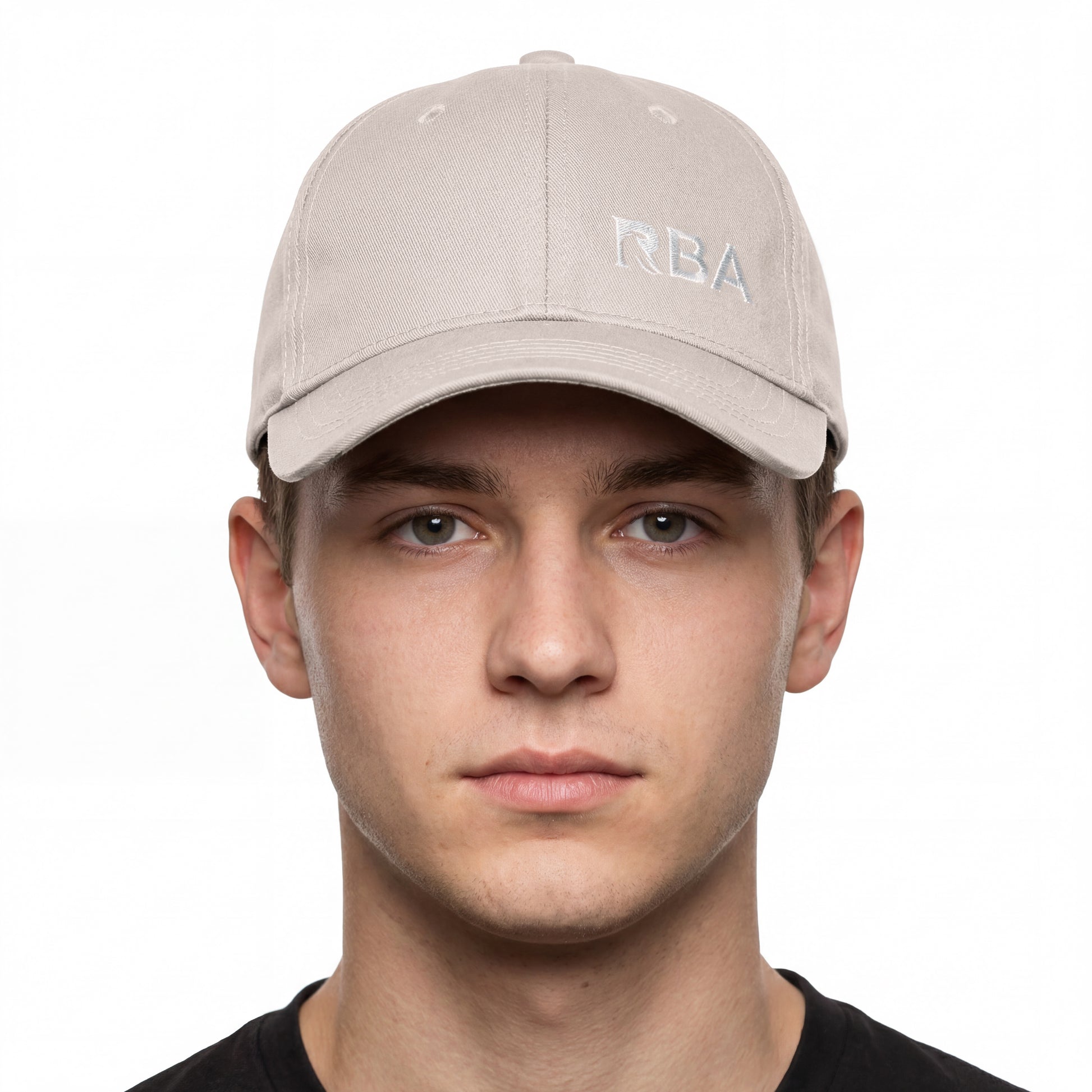 Man wearing a beige cap with 'RBA' logo on a white background