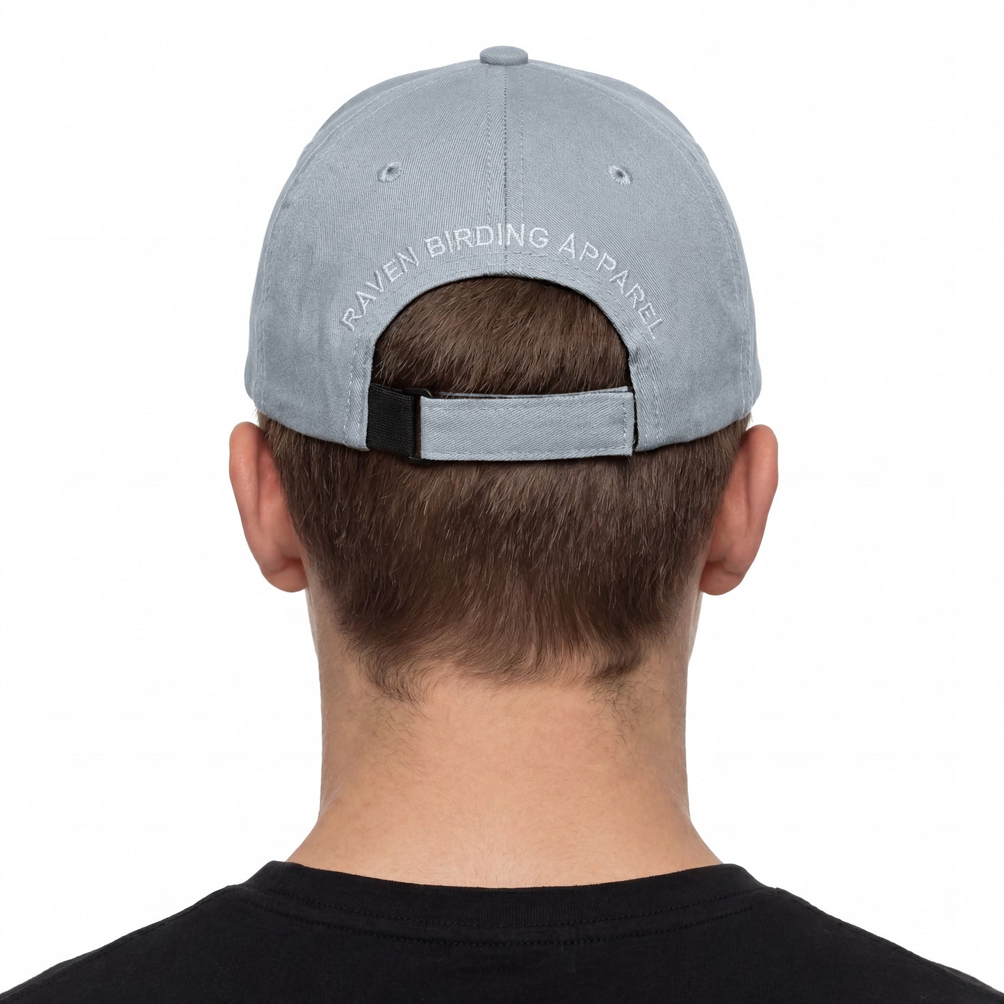 Person wearing a gray cap with 'Raven Birding Apparel' logo on a white background